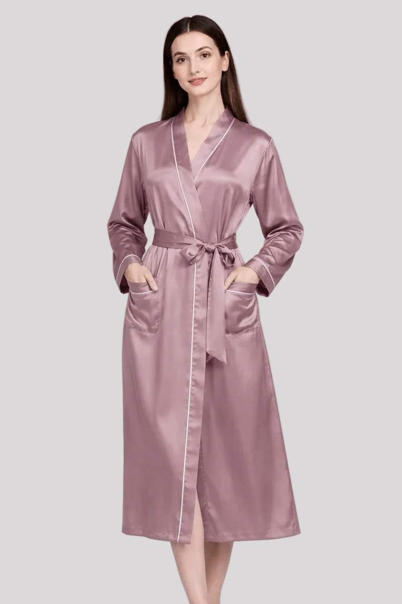 Woman wearing a pink silk robe on a white background