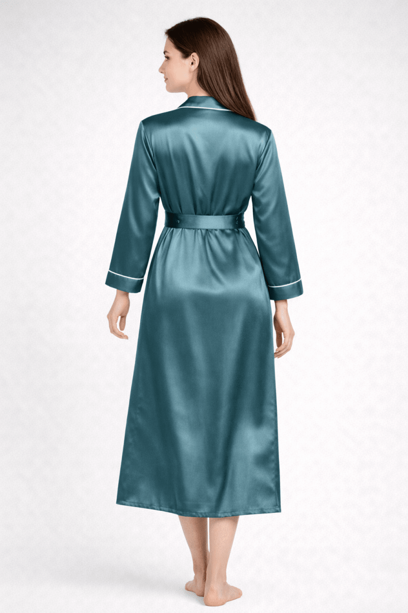 Woman wearing a teal silk robe on a white background