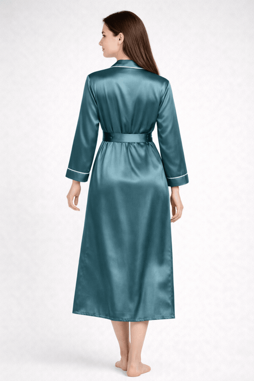 Woman wearing a teal silk robe on a white background