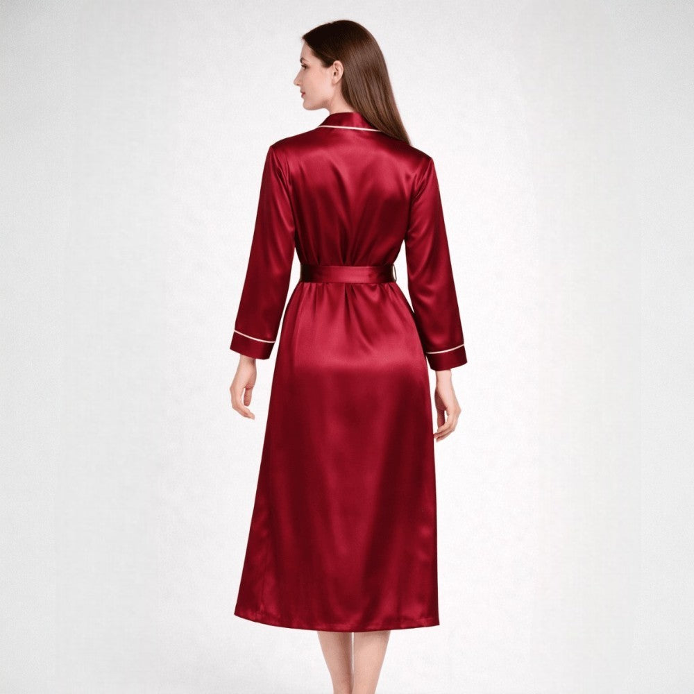 Red silk robe worn by a model on a white background