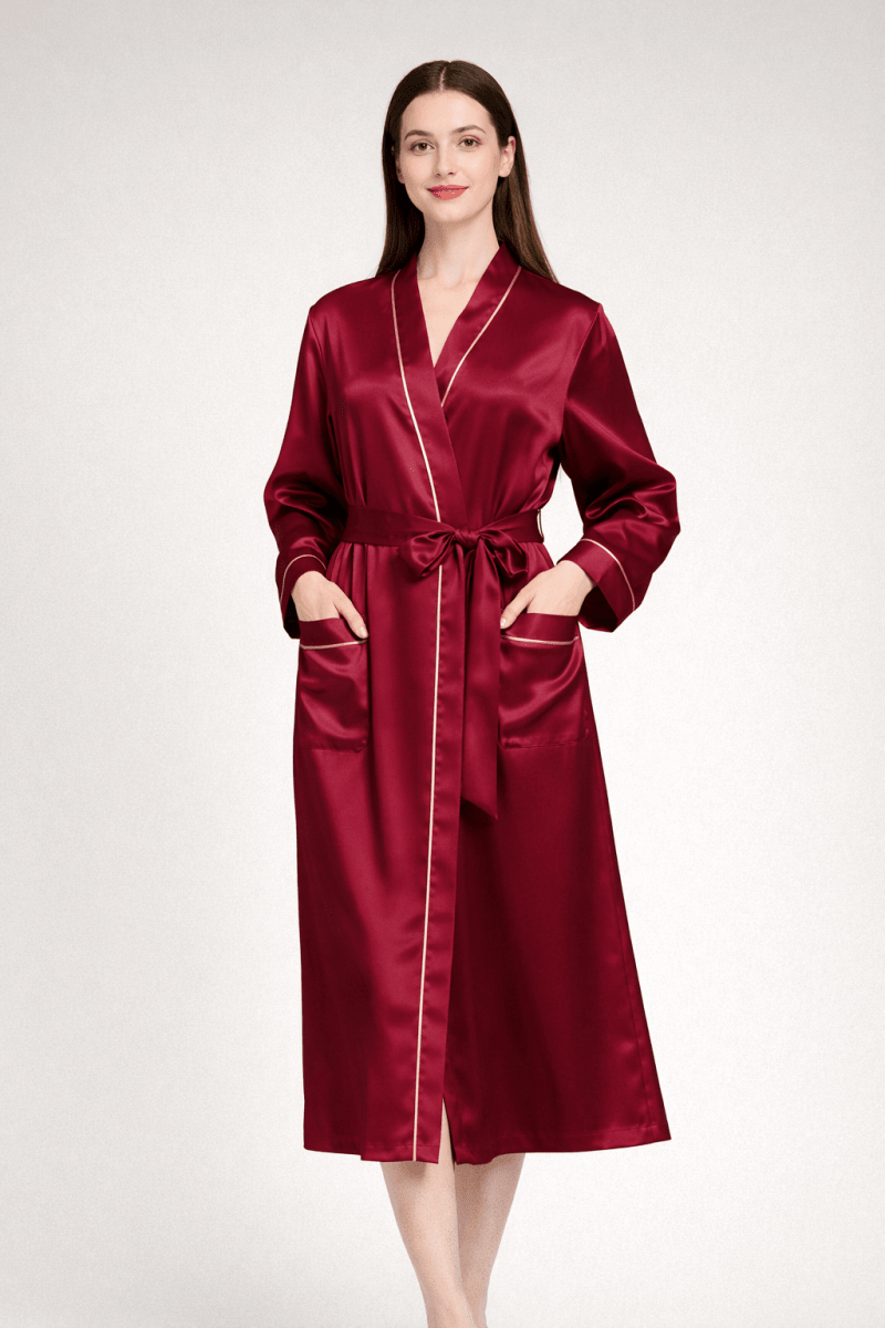 Woman wearing a burgundy silk robe on a white background