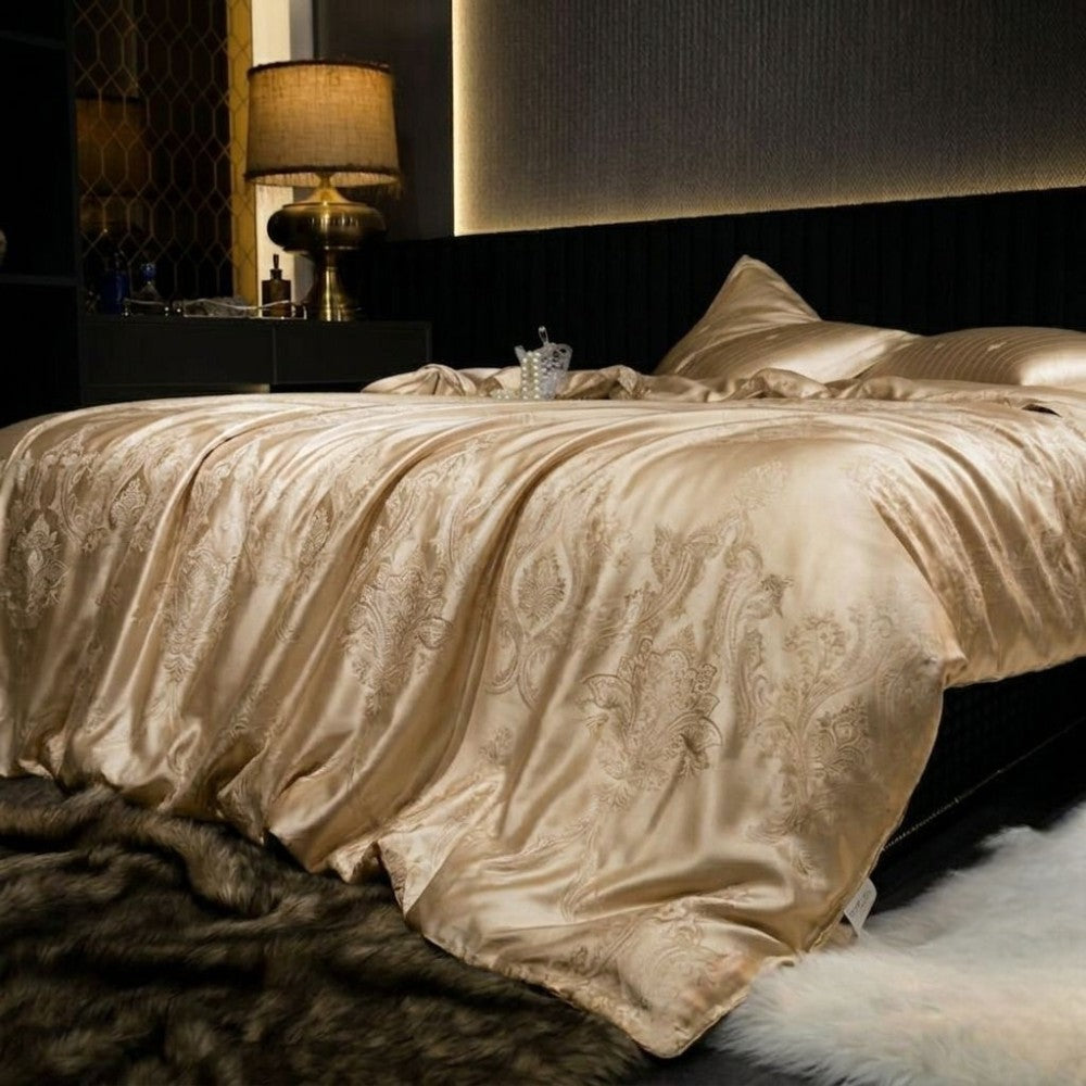 Luxurious bedroom with silk champagne gold bedding and decorative pillows.