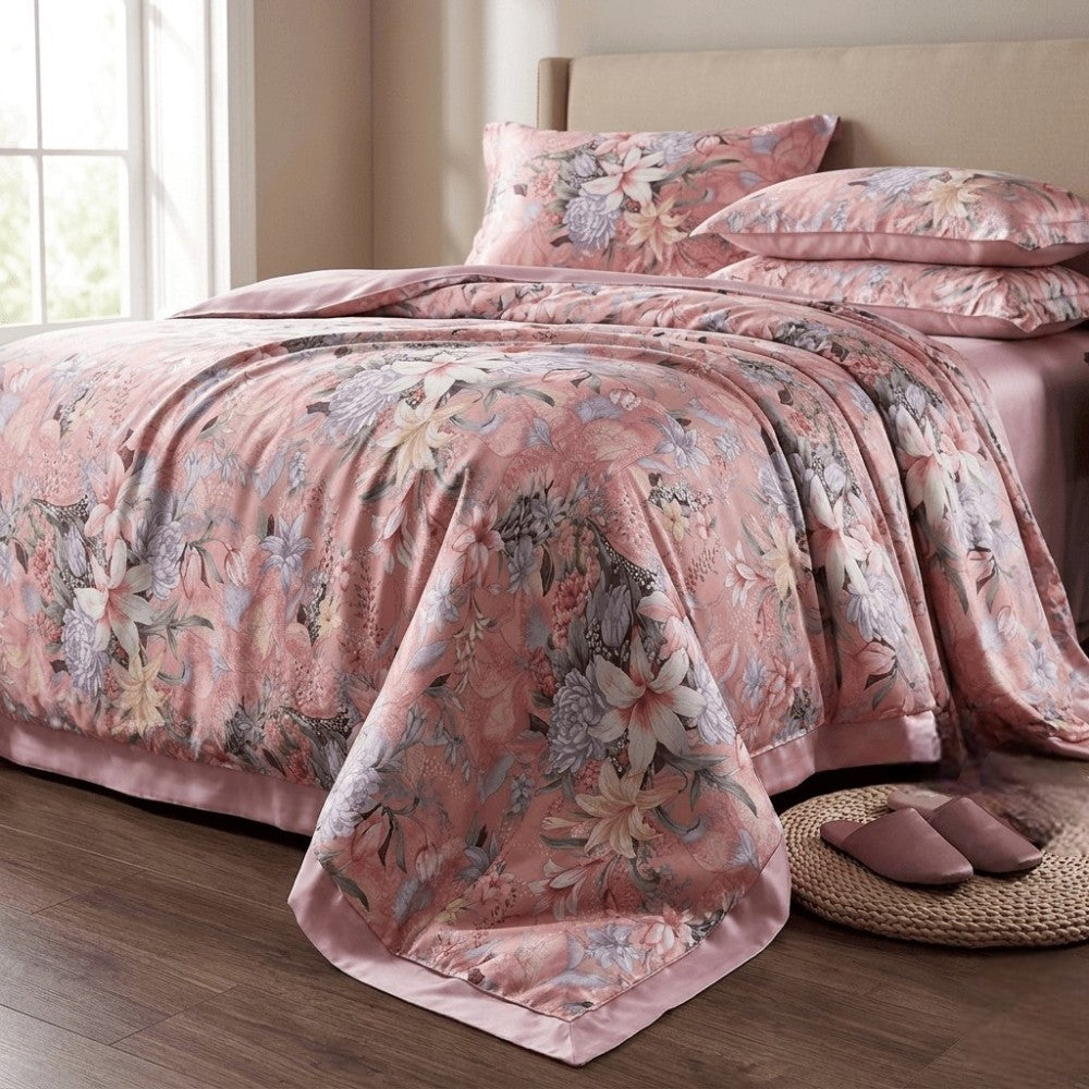 Floral patterned pinksilk bedding set on a bed in a bedroom.