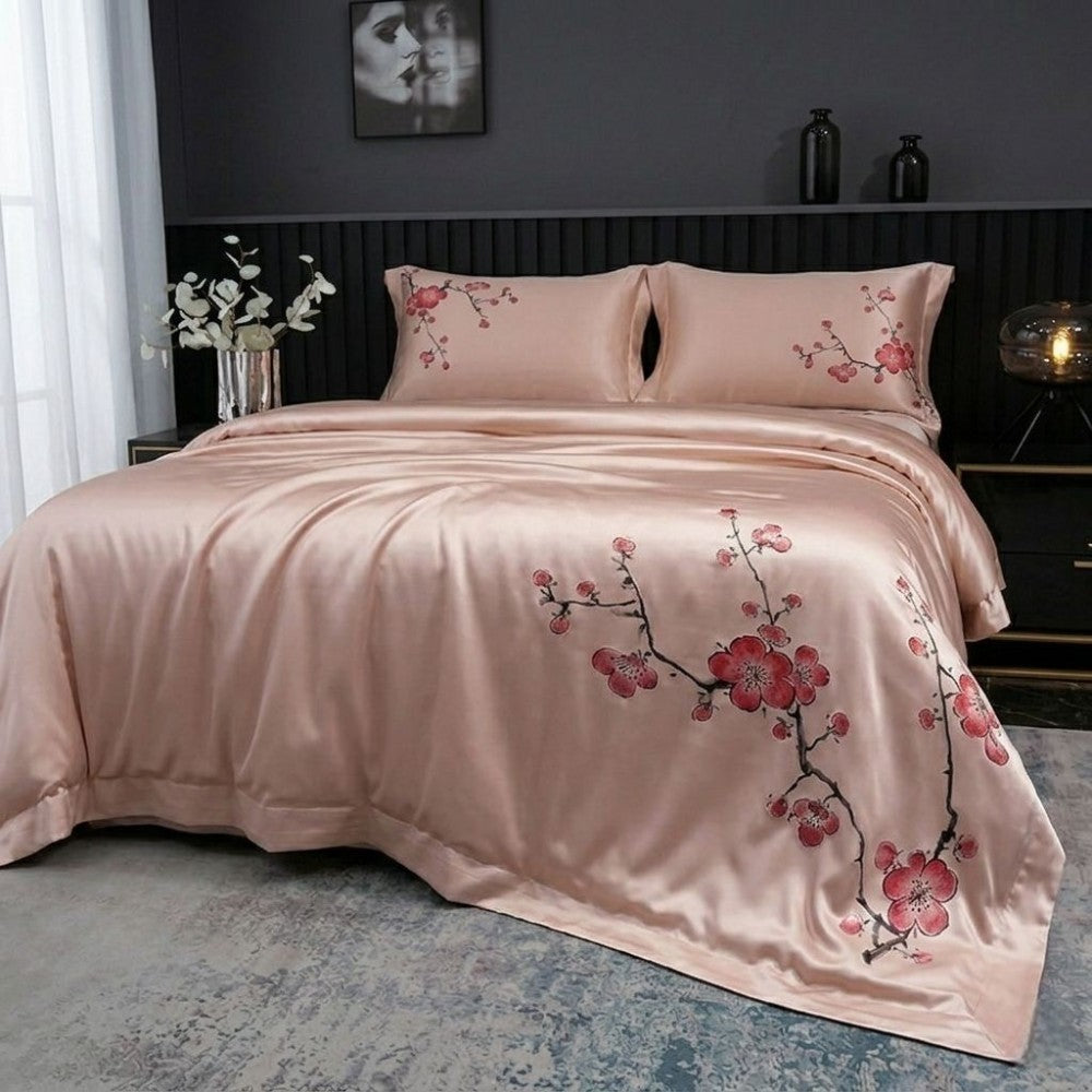 Pink floral bedding set on a bed in a bedroom setting.