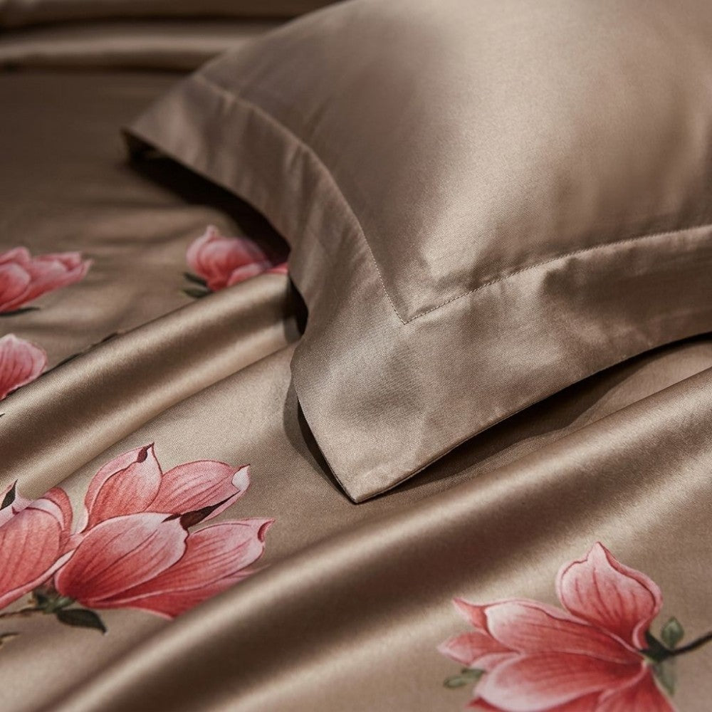 Silky satin sheet set with pink floral design on a brown background