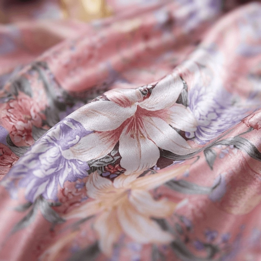 Close-up of floral fabric with pink, purple, and white colors.