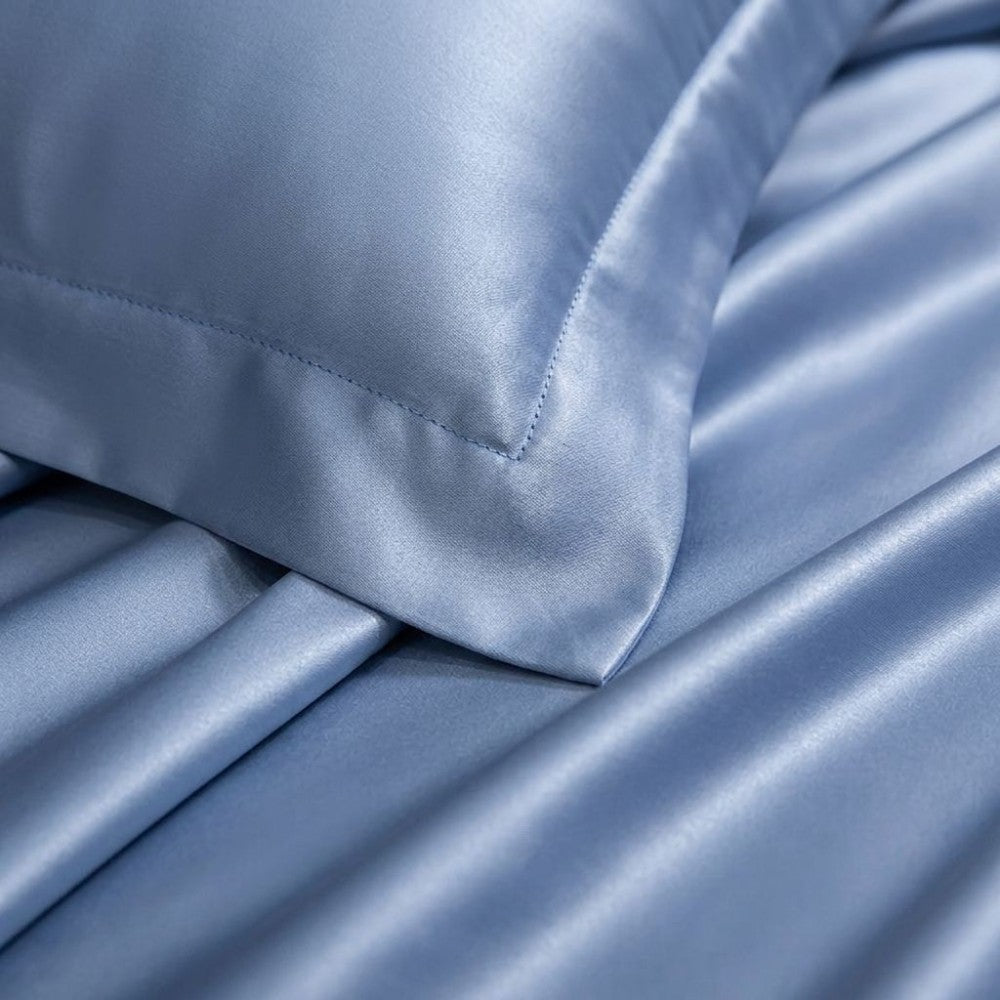 Close-up of light blue silk pillowcase fabric with a smooth texture
