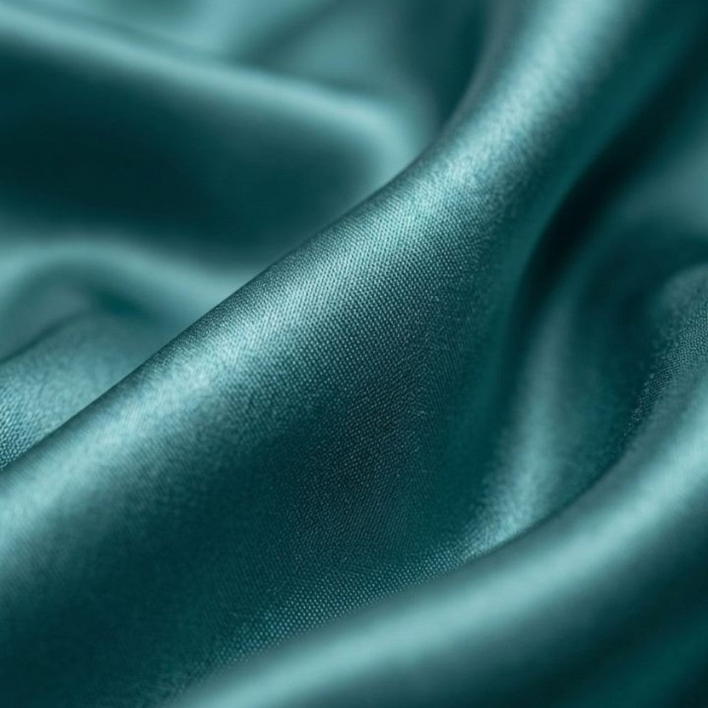 Close-up of teal silk fabric with folds