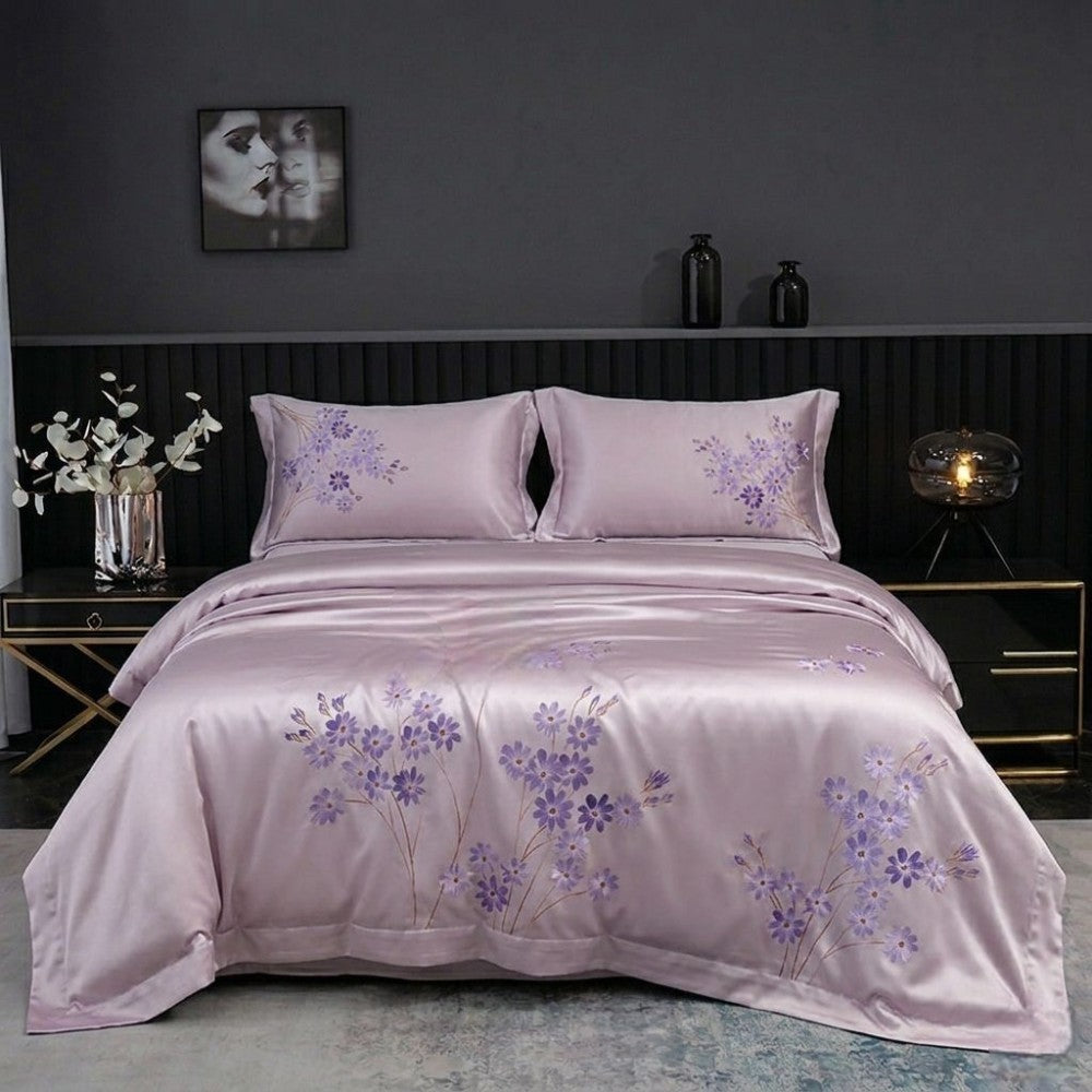Purple floral bedding set on a bed in a bedroom setting with dark walls and decor.