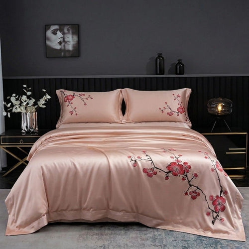 Pink floral bedspread on a bed in a bedroom setting with dark walls and decor.