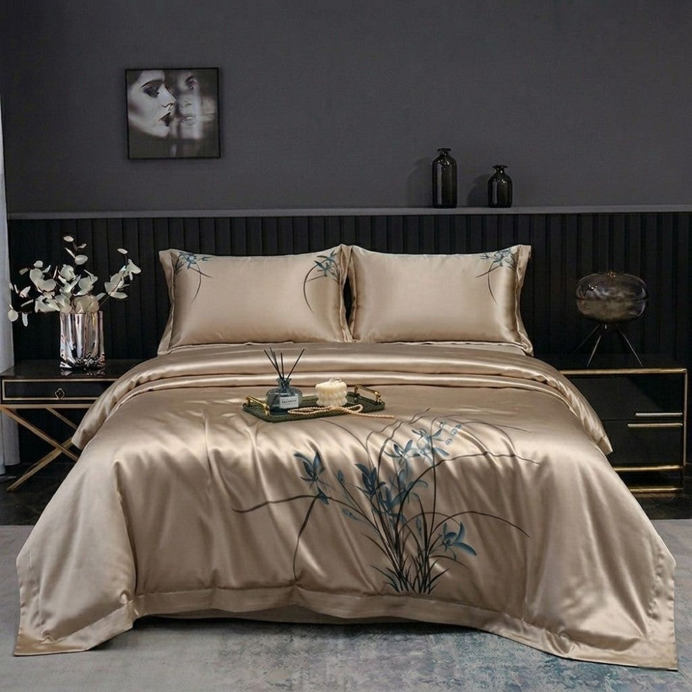 Beige silk bedding set with floral embroidery in a bedroom setting.