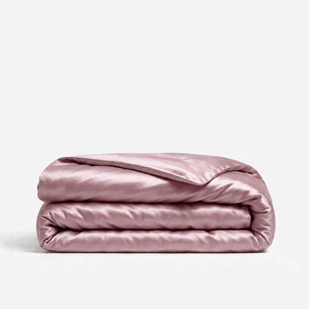 A folded light purple silk duvet cover