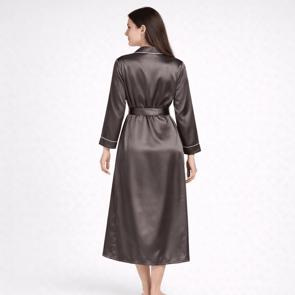 Woman wearing a long silk robe on a white background