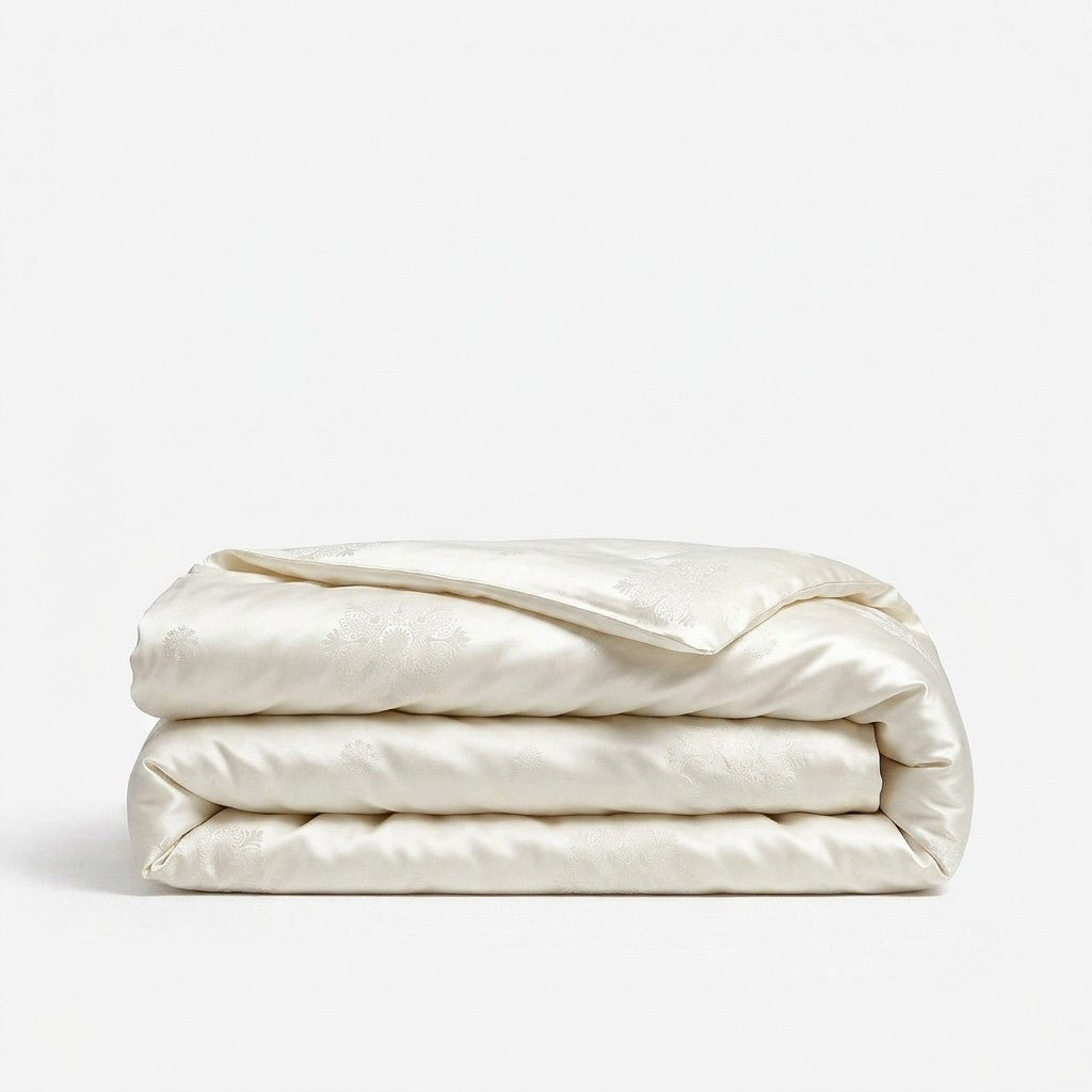 A folded white silk duvet cover