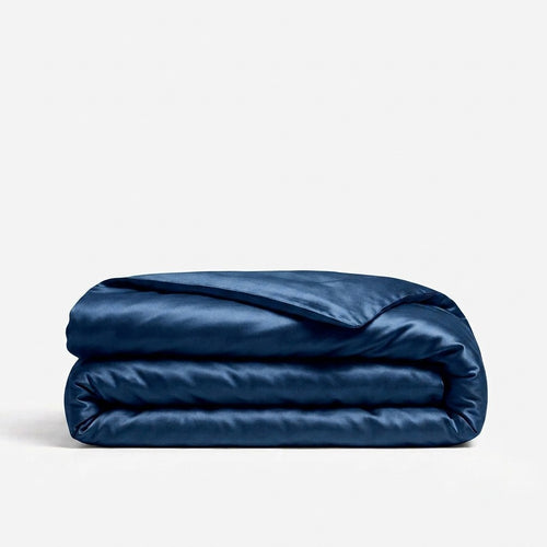 A folded navy blue silk duvet cover