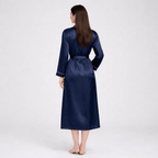 Woman wearing a navy silk robe on a white background