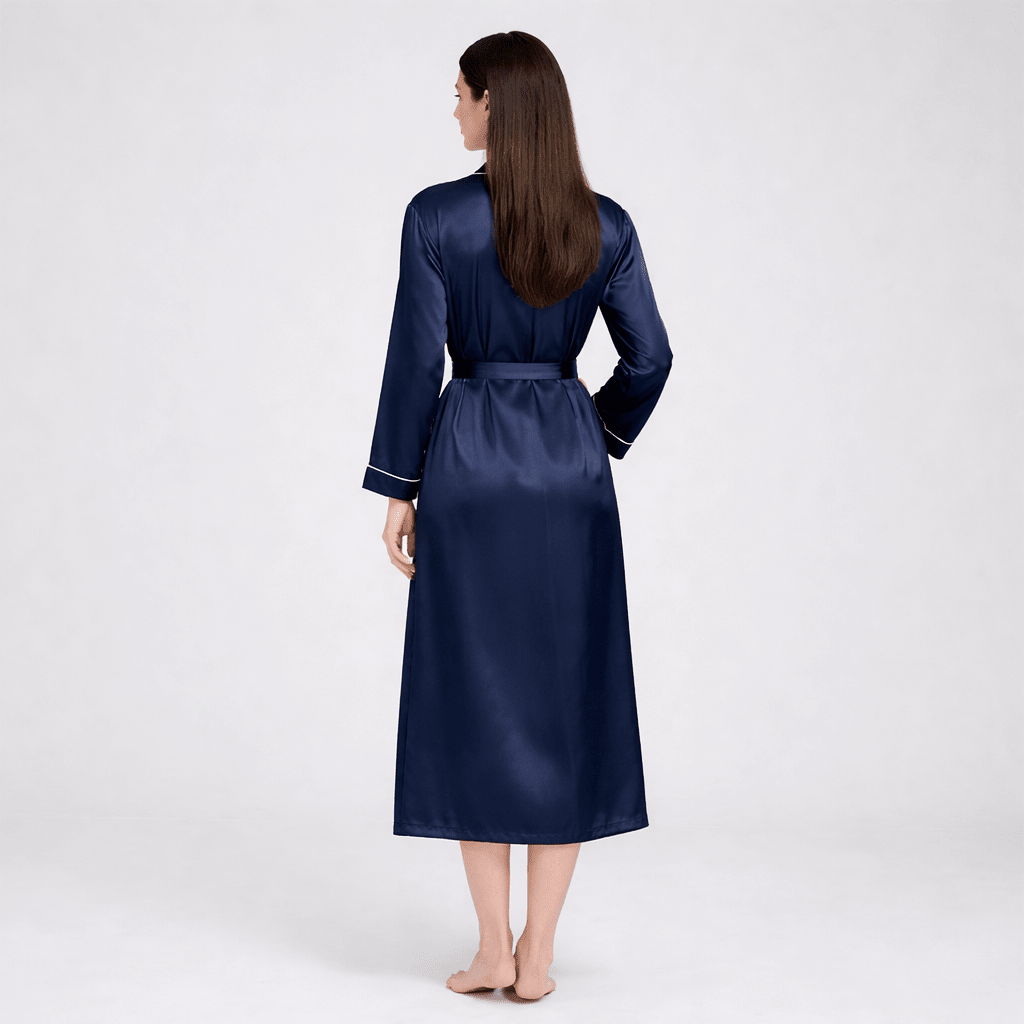 Woman wearing a navy silk robe on a white background