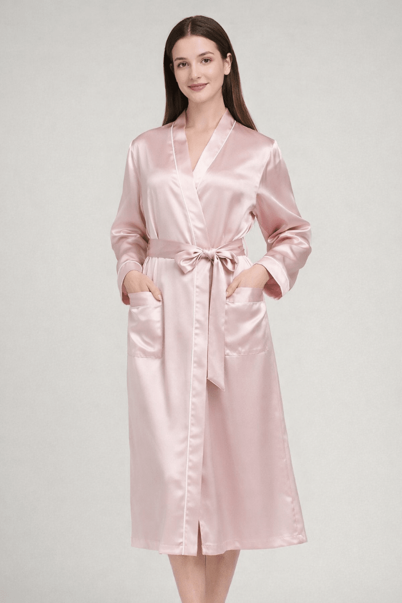 Woman wearing a pink silk robe on a white background