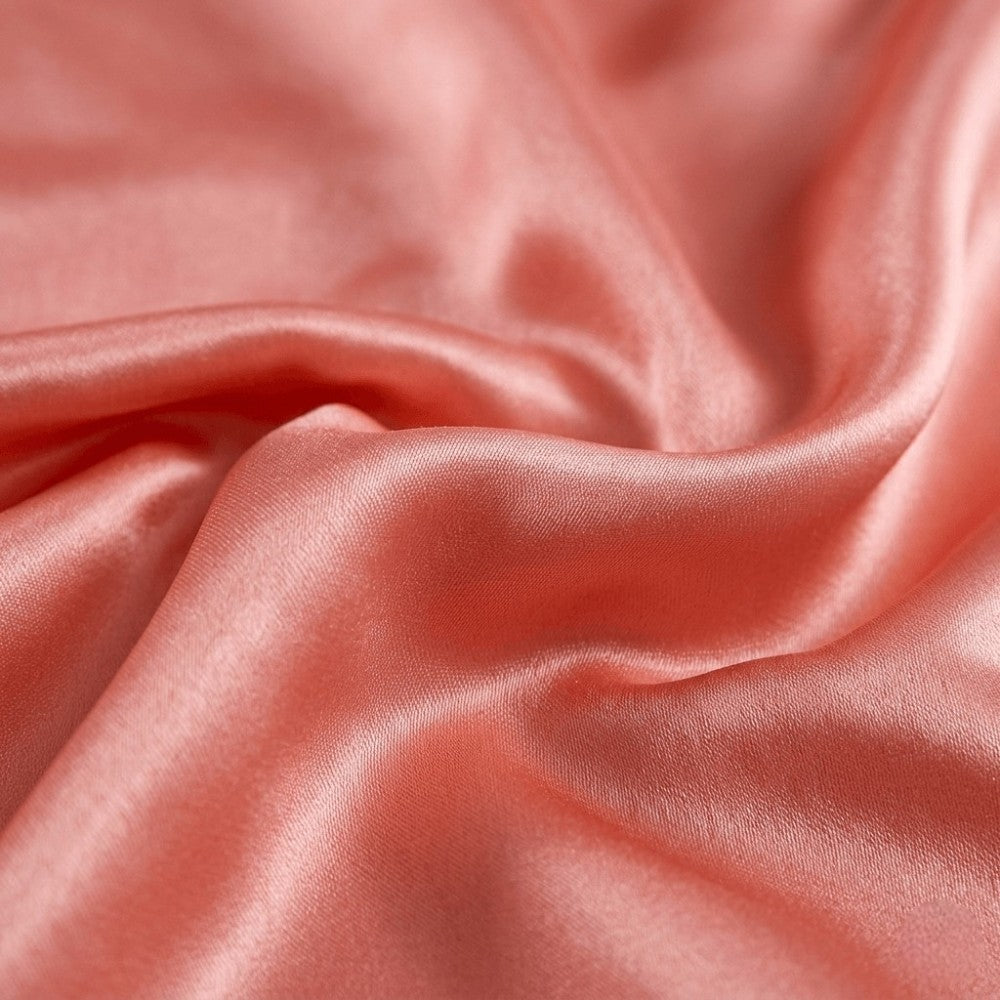 Close-up of pink silk fabric with folds