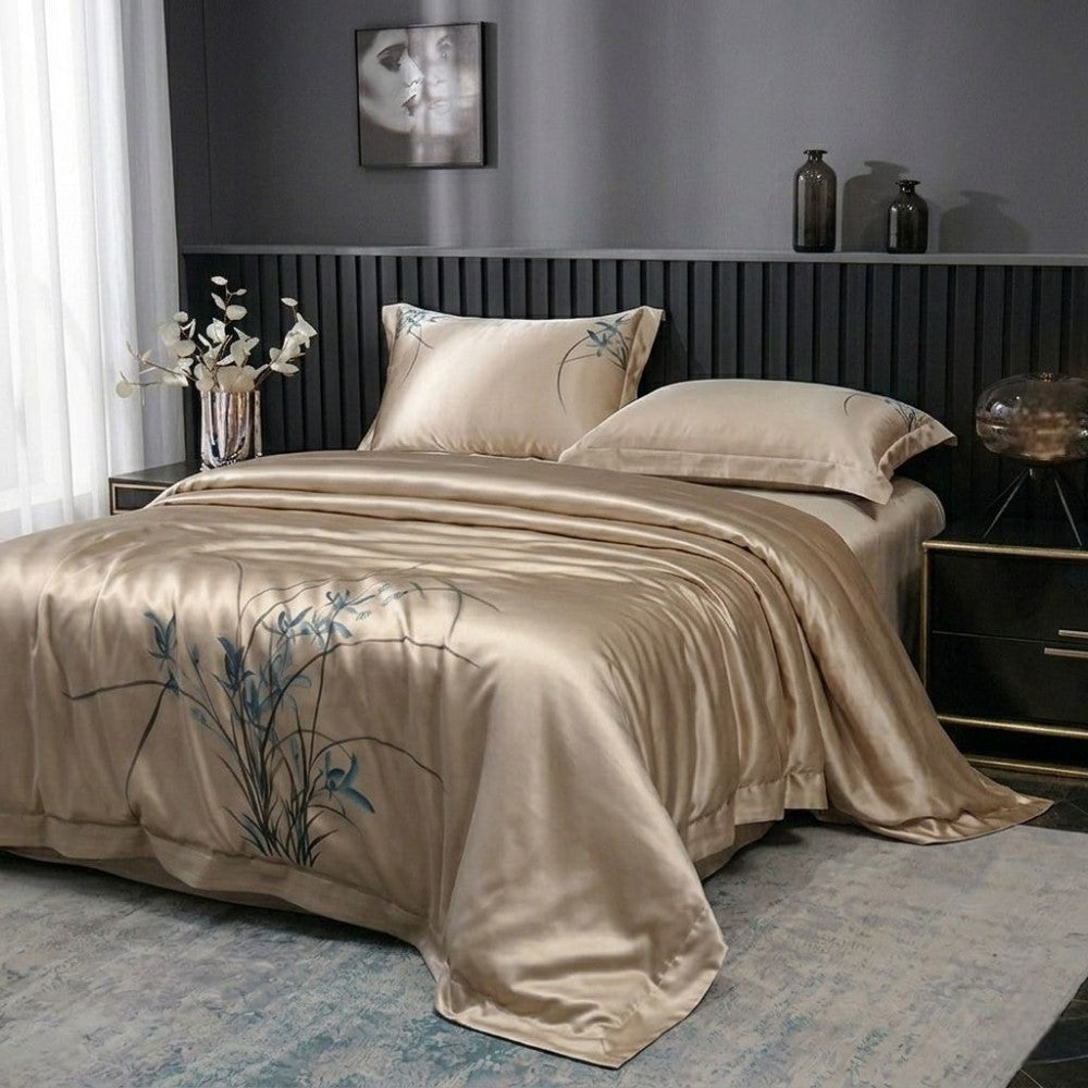 Beige silk bedding set on a bed in a bedroom with decorative elements.