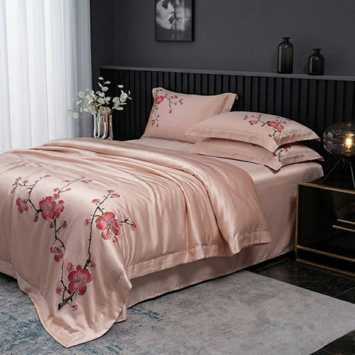 Pink floral bedding set on a bed in a bedroom setting.